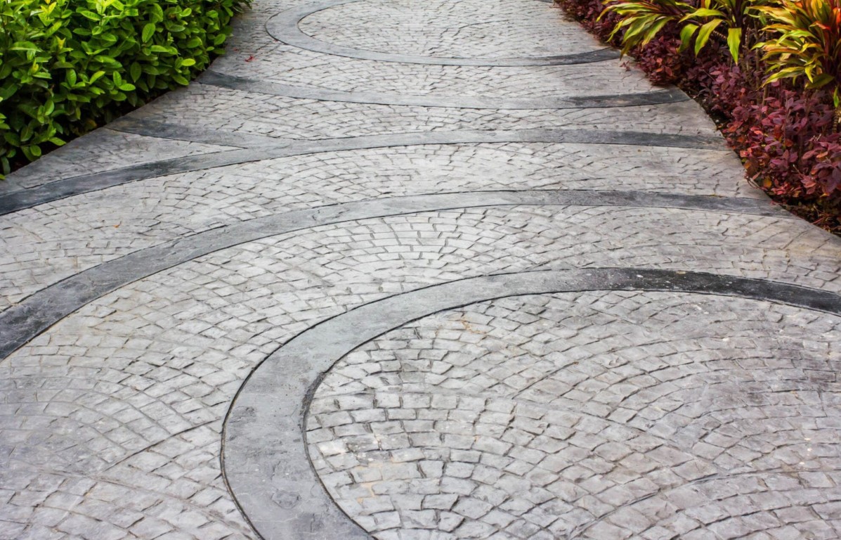 Decorative stamped concrete walkway with circular pattern design
